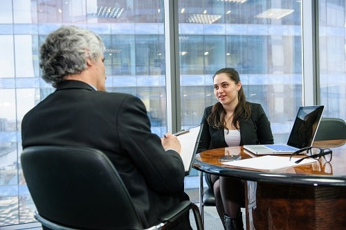 Mature businessman and young business woman discussing