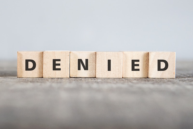 Word denied spelled on wood blocks