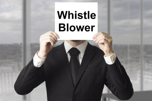 businessman in black suit hiding face behind sign whistle blower