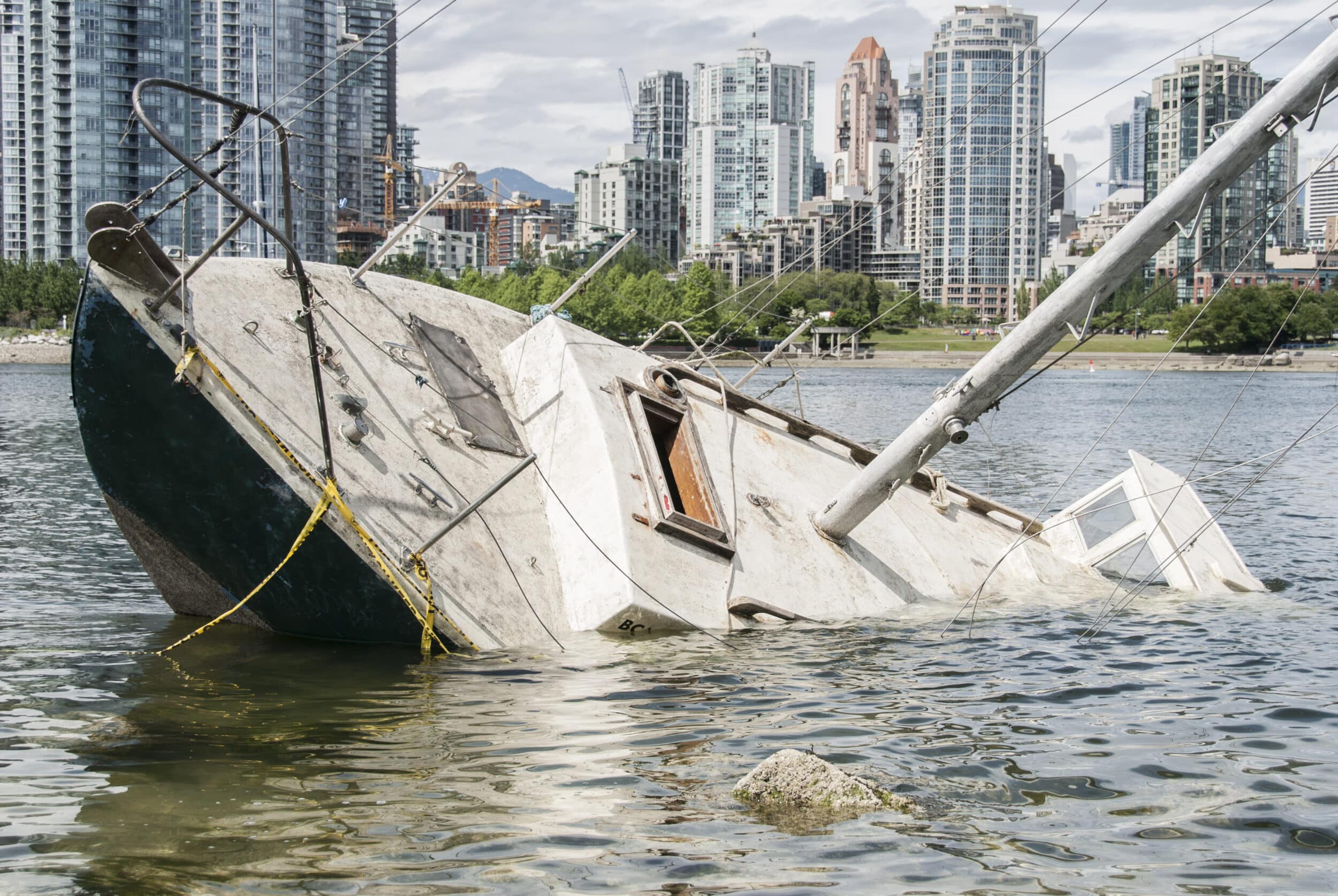 Capsized boat is sinking near the shore following an accident
